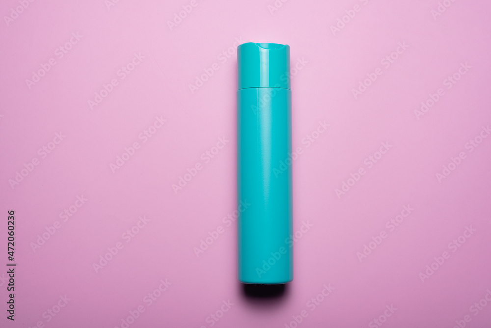 Hair shampoo bottle on the pink flat lay background. Top view. Hair shampoo bottle on the pink flat lay background. Top view.