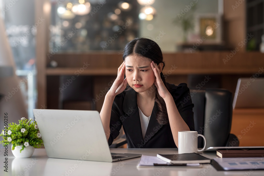 Beautiful young Asian businesswoman feeling tired from overworked. Beautiful young Asian businesswoman feeling tired from overworked.