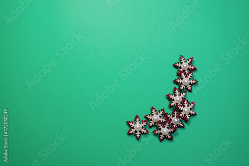 Toy Christmas stars toy on the green flat lay background with copy space.