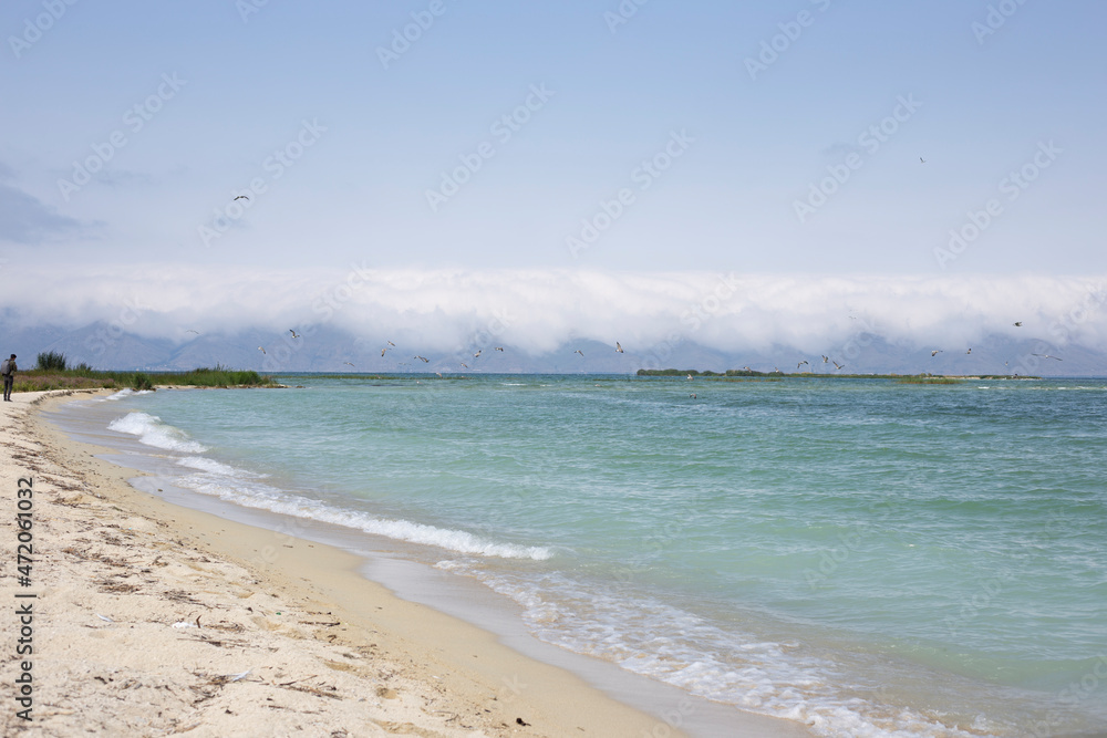 Sand beach with blue sea and blue sky