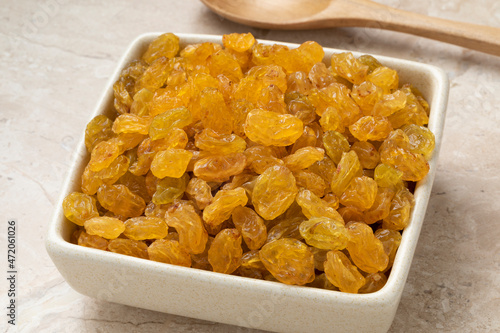 Bowl with sweet golden Sultana raisins close up 