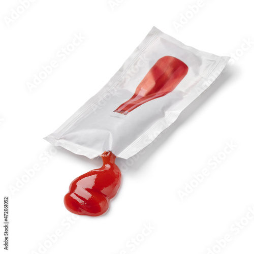 Tomato ketchup from a disposable sachet isolated on white background 