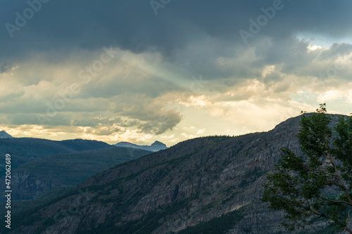 Golden hour, as viewed while driving on the Going to the Sun Road in Glacier National Park in Montana on a beautiful sunny summer evening  © Sitting Bear Media