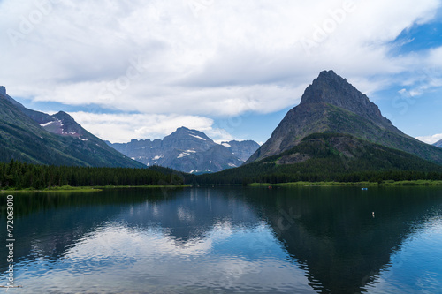 Swiftcurrent Lake at Many Glacier in Glacier National Park in Montana on a cloudy summer day © Sitting Bear Media