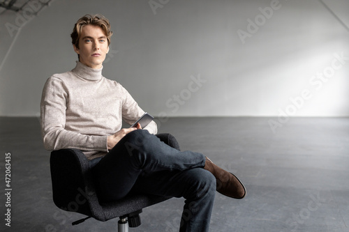 Handsome businessman sitting on office chair photo