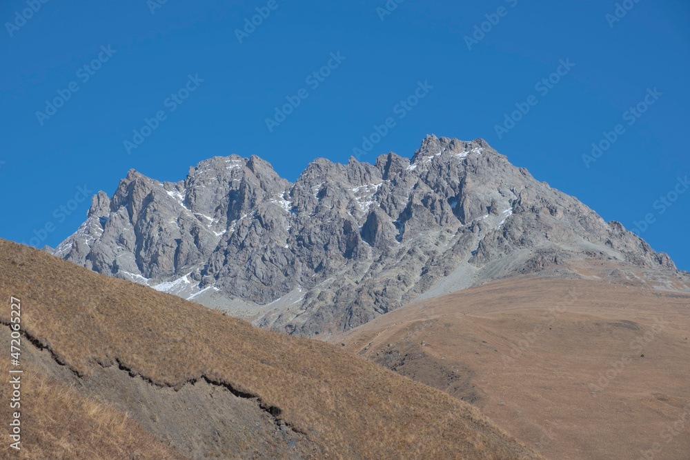 Scenic autumn mountain landscape with snow peaks, Digor Gorge, Northern Ossetia, Caucasus, Russia