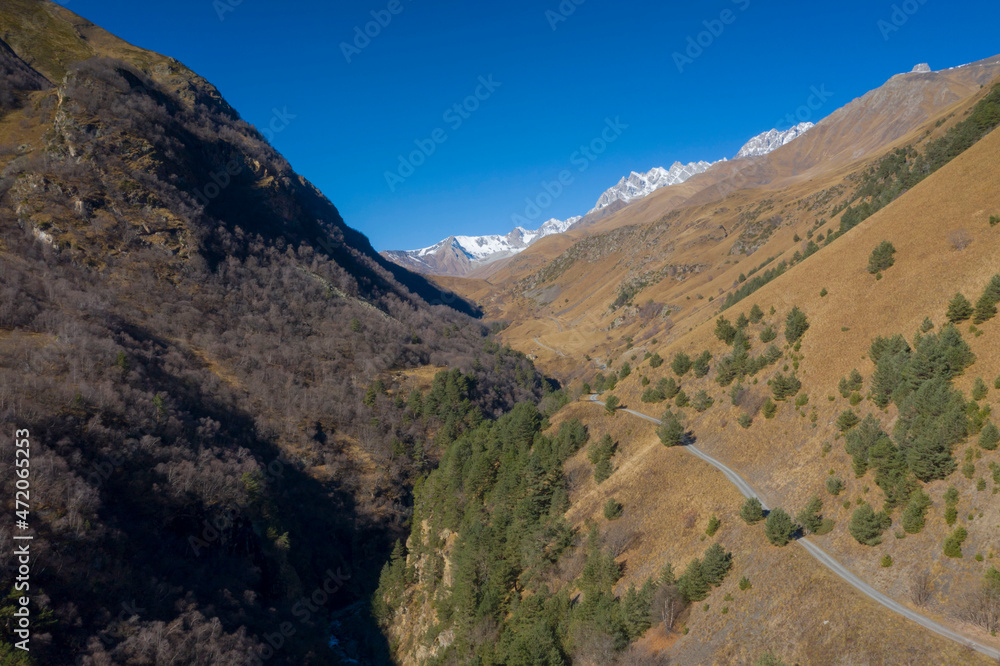 Scenic autumn mountain gorge landscape with snow peaks, Digor Gorge, Northern Ossetia, Caucasus, Russia