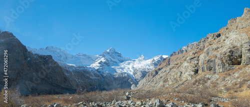 Scenic autumn mountain gorge landscape with snow peaks, Tana glacier, Digor Gorge, Northern Ossetia, Caucasus, Russia