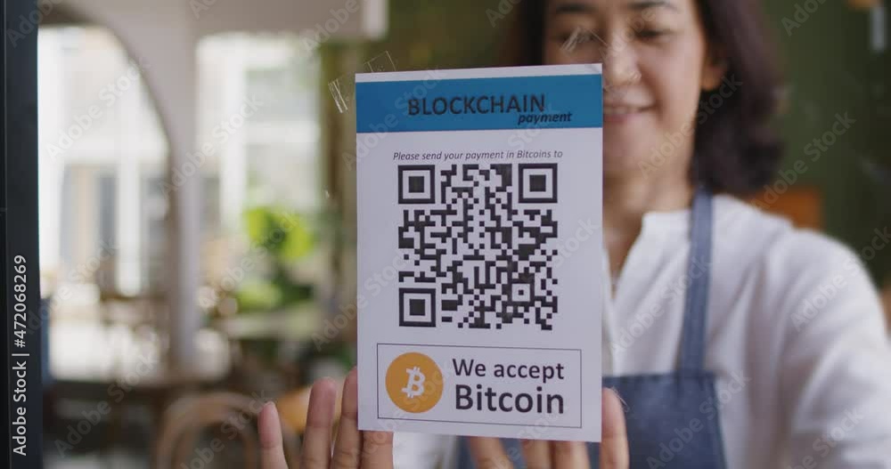 Asia people small SME owner stick QR code placard text label signage poster on glass virtual cash digital money service. Cryptocurrency Bitcoin ethereum blockchain logo on modern coffee cafe shop.  