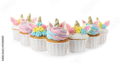 Many cute sweet unicorn cupcakes on white background