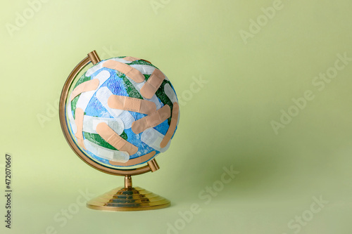 Globe of Planet Earth stuck with numerous band aids