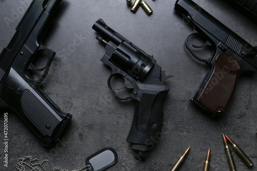 Plakat w ramie Flat lay composition with professional guns on black background