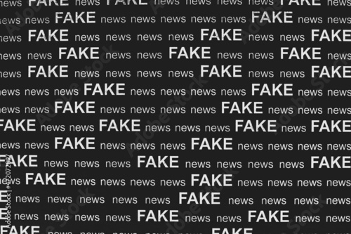 Text - FAKE news - printed on black sheet of paper