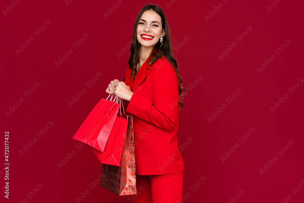 attractive woman in red with shopping bags sale on red background attractive woman in red with shopping bags sale on red background