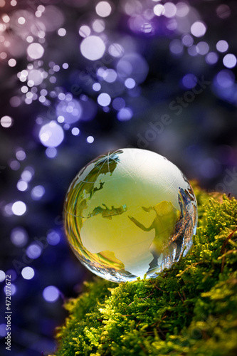 Christmas new year eve Earth ball - Environmetal green planet earth in nature background with bauble sphere. 2024