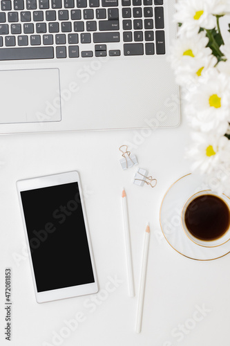 Flat lay mockup smartphone blank screen, laptop, cup of coffee on a white background