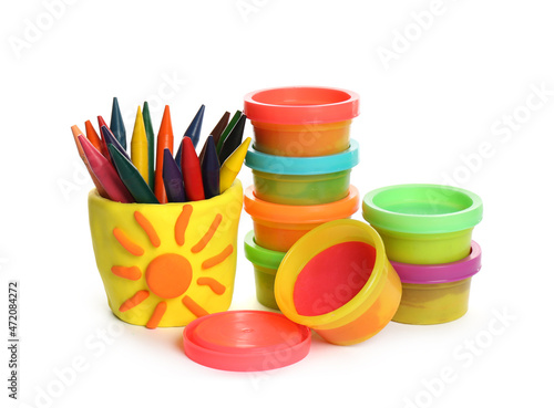 Set of bright play dough with colorful pencils on white background