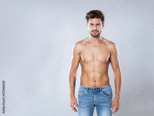 Quadro su tela Handsome man without a shirt standing straight to the camera