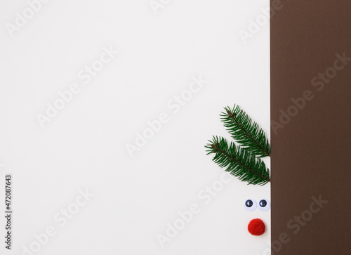 Decorative deer muzzle with horns made of coniferous branches, the basis for a greeting card for Christmas and new Year