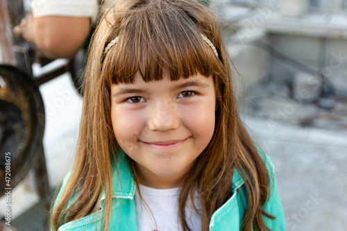 Smiling cute schoolgirl girl with brown hair