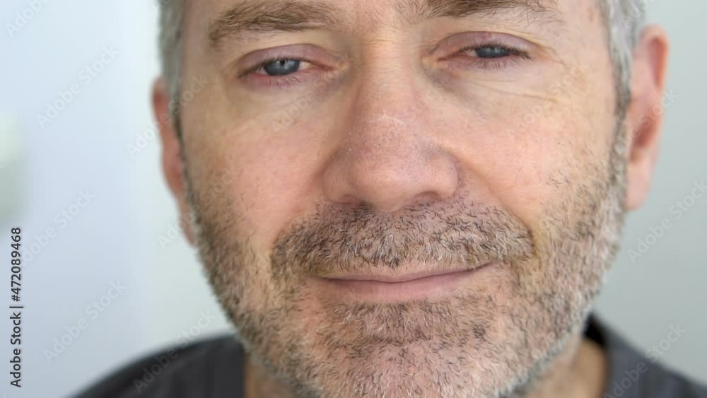 Close-up portrait of senior man with blue eyes and grey beard on white wall background, fathers day concept Close-up portrait of senior man with blue eyes and grey beard on white wall background, fathers day concept