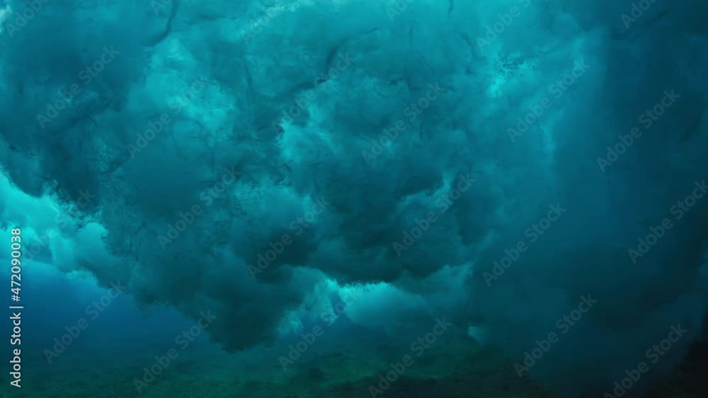 Ocean wave. Crystal clear ocean wave rolls and breaks. Underwater view of the Indian Ocean's wave breaking on the Maldivian shore Ocean wave. Crystal clear ocean wave rolls and breaks. Underwater view of the Indian Ocean's wave breaking on the Maldivian shore