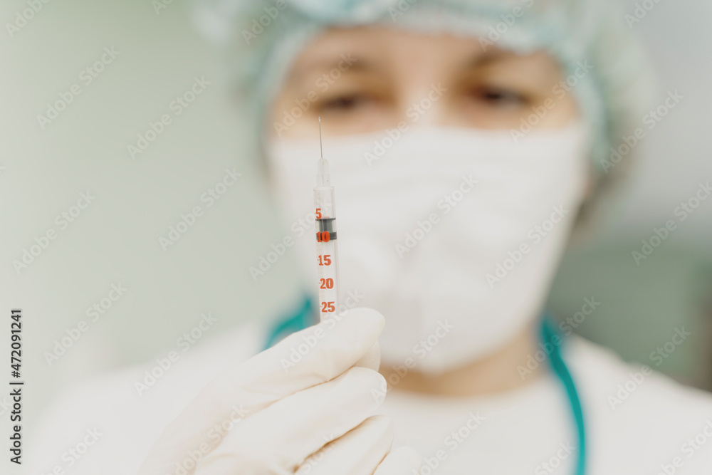 The doctor holds a syringe with an injection in his hands. Selected Focus. High quality photo The doctor holds a syringe with an injection in his hands. Selected Focus. High quality photo