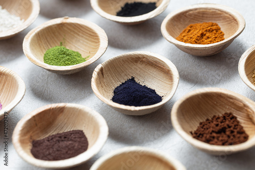 Set of natural pigment powder from herbs in small bowls. Dye from nature.