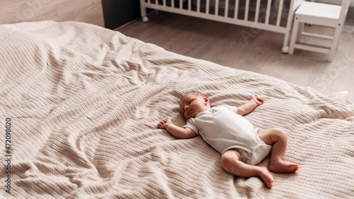 child sleeping on bed