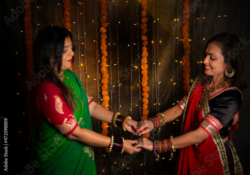Sisters in Indian wear holding hands  photo