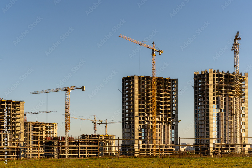 Photo of the construction site, building of high buildings and cranes. Constructional concept Photo of the construction site, building of high buildings and cranes. Constructional concept