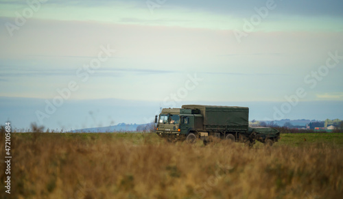 british army MAN SV 4x4 vehicle truck with attached trailer driving along a dirt track in action on a military exercise, Salisbury Plain UK © Martin