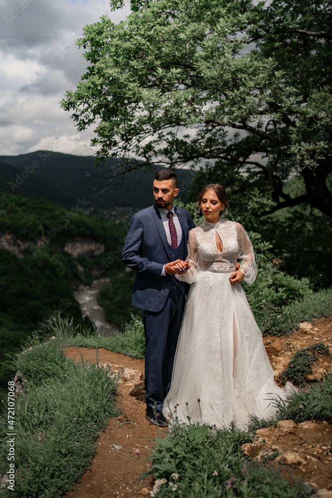 a beautiful couple of newlyweds in a wedding ceremony in the mountains