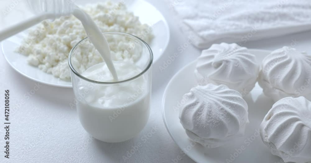 Filling glass with milk close up Filling glass with milk close up
