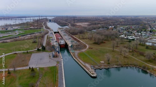 Two cargo ships prepare to cross the locks of the Beauharnois Canal in the St Lawrence Seaway, near Montreal, Quebec. High quality 4K aerial view.