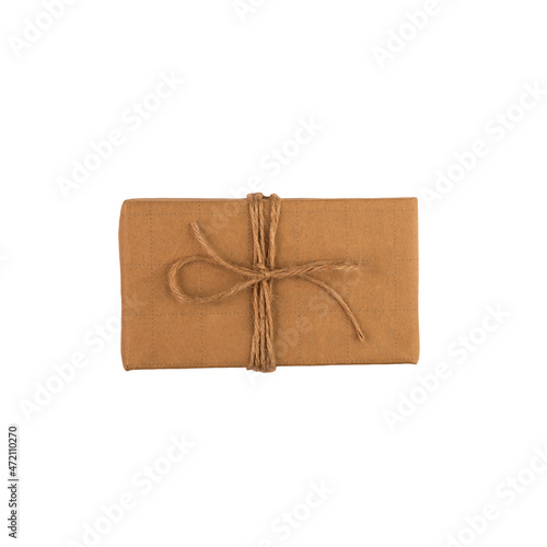 A brown paper wrapped gift isolated on a white background. Christmas gift composite