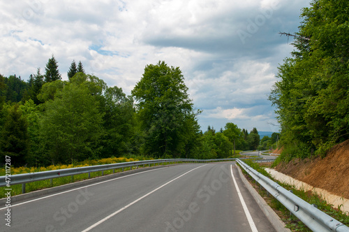 highways in the mountains against the background of the sunny sky and the white clouds © mikhailgrytsiv