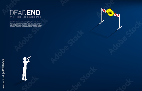 Silhouette of businessman look in telescope with dead end signage . Concept of wrong decision in business or end of career path.