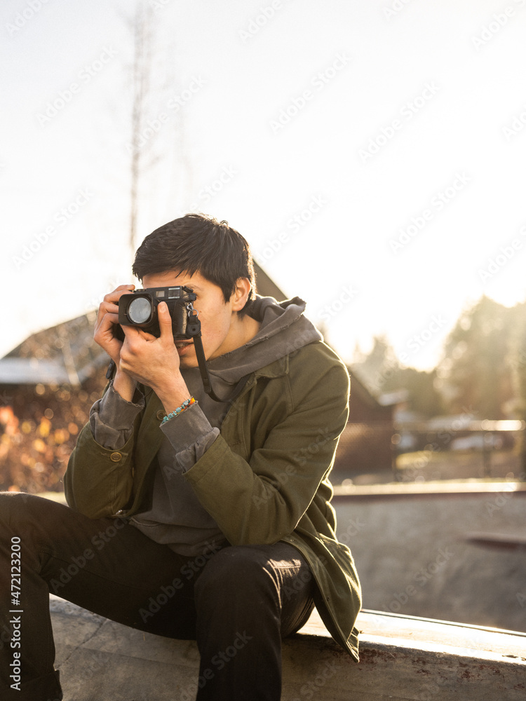 Young Indigenous adult male photographer outdoors Young Indigenous adult male photographer outdoors