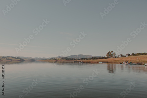 calm lake water with land on the horizon