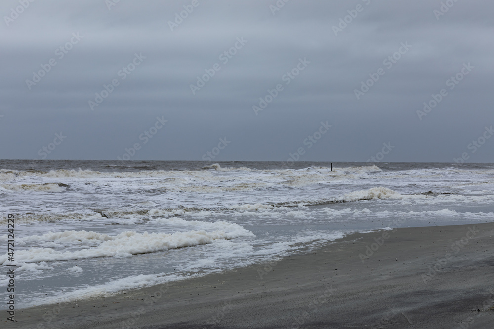 Heavily overcast skies during a storm on the coast of South Carolina, heavy surf, horizontal aspect Heavily overcast skies during a storm on the coast of South Carolina, heavy surf, horizontal aspect