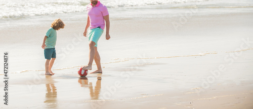 kid and cropped dad running on beach in summer vacation with ball  copy space  best friends