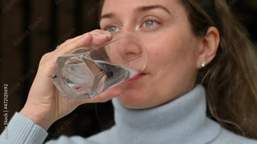 Woman drinking water from a glass at the office Woman drinking water from a glass at the office