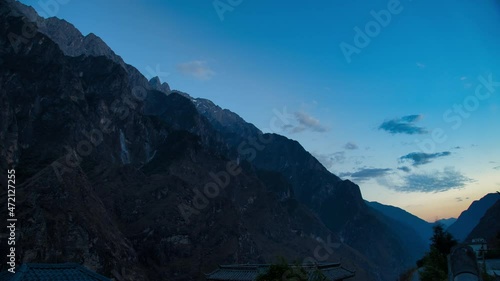 Time Lapse, Tiger Leaping Gorge. Steep mountain range during the period from day to night and moving clouds