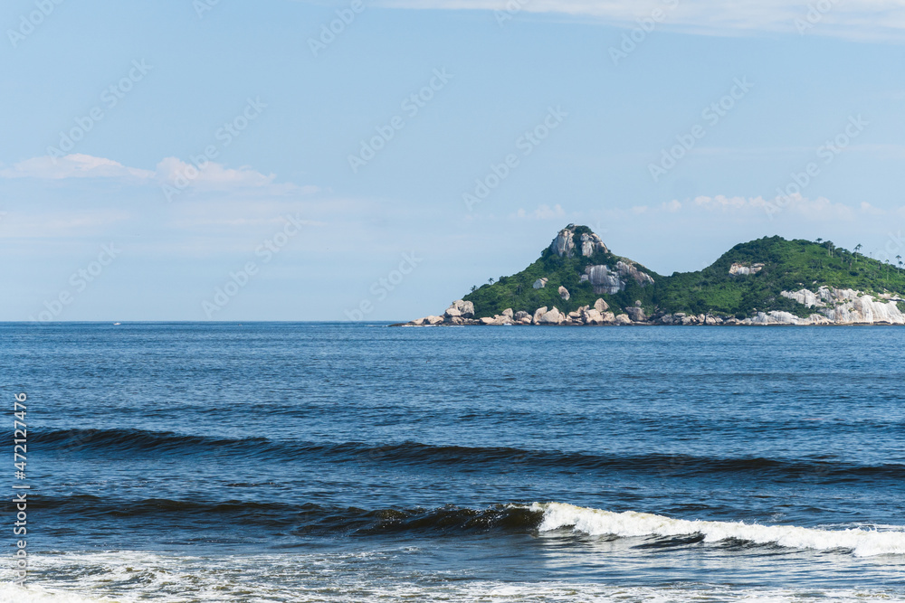 Tijuca Islands in the background, seen from Barra da Tijuca beach, Rio de Janeiro, Brazil. Day with blue sky and some clouds Tijuca Islands in the background, seen from Barra da Tijuca beach, Rio de Janeiro, Brazil. Day with blue sky and some clouds