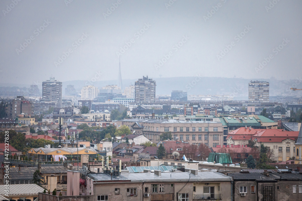 Skyline of New belgrade, or novi beograd, in Serbia, since from Zemun, with bruatlist residential skyscraper towers blurred due to an autumn foggy rain. Novi beograd is business district of Belgrade