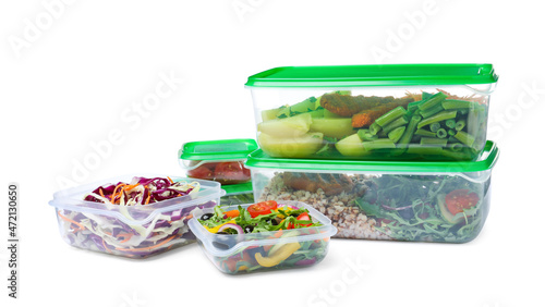 Canvas Print Plastic containers with fresh food on white background