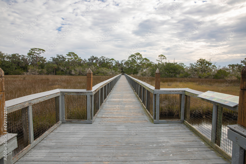 An elevated boardwalk over the salt marsh at Fort Mose Historic State Park. 