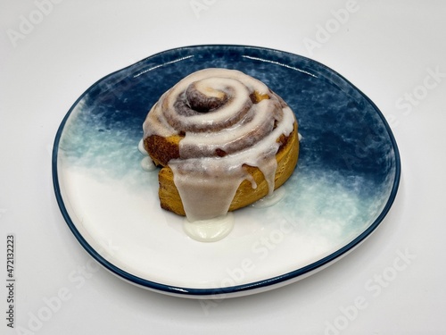Delicious hot cinnamon roll with icing  photo
