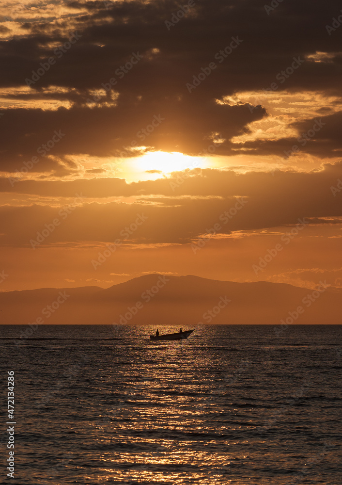 Fisherman on the sunset rays